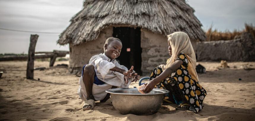 Mahamat y Sara se lavan las manos en la puerta de su vivienda en la comunidad de Kamkalaga. En esta región de Chad donde los recursos hídricos son muy escasos Oxfam Intermón ha rehabilitado dos pozos de agua y ha instalado un tanque en el centro de salud.