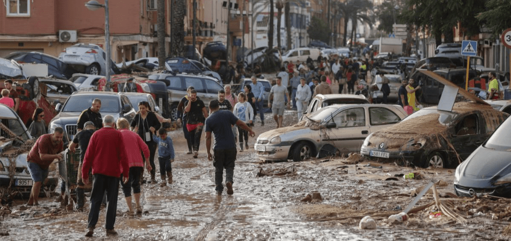 Varias personas caminan por una de las calles afectadas en Paiporta (València), tras las fuertes lluvias causadas por la DANA, a 30 de octubre de 2024.-Manu Bruque / EFE